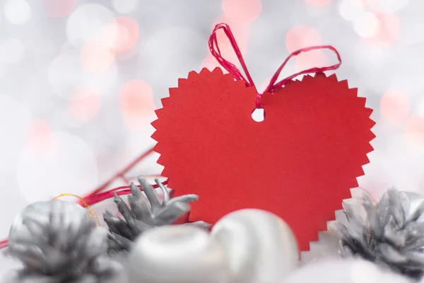 Christmas card with heart, balls, pines and bokeh — Stock Photo, Image