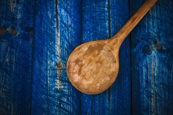 Old wooden spoon blue boards — Stock Photo, Image