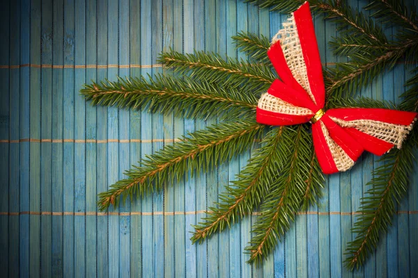 Christmas card with bow on spruce twig — Stock Photo, Image