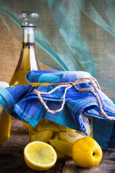 Tarro de alcohol membrillo licor en rodajas de frutas preparar entorno de madera —  Fotos de Stock