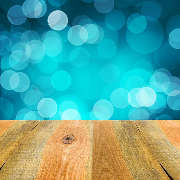Blue bokeh background wooden table — Stock Photo, Image