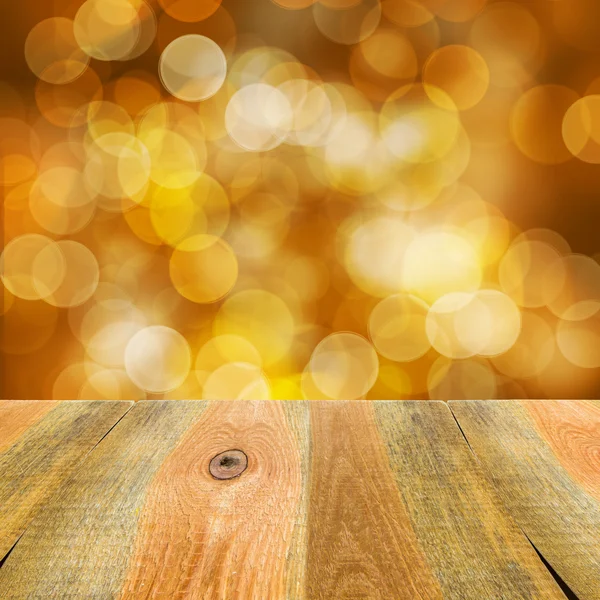 Oranje geel bokeh achtergrond houten tafel — Stockfoto