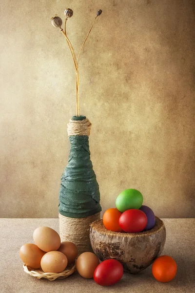Still life colorful Easter eggs basket vase — Stock Photo, Image