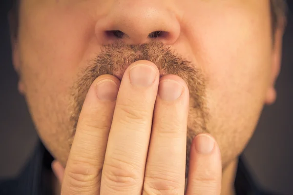 Man covering mouth hand laughing silence — Stock Photo, Image