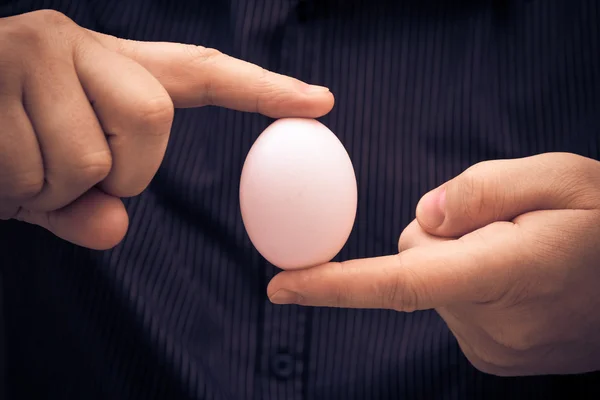 White hen egg held fingers — Stock Photo, Image