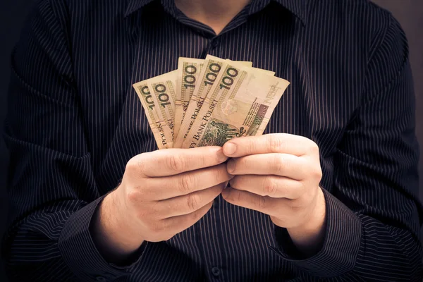 Muž drží ruce polský peníze — Stock fotografie