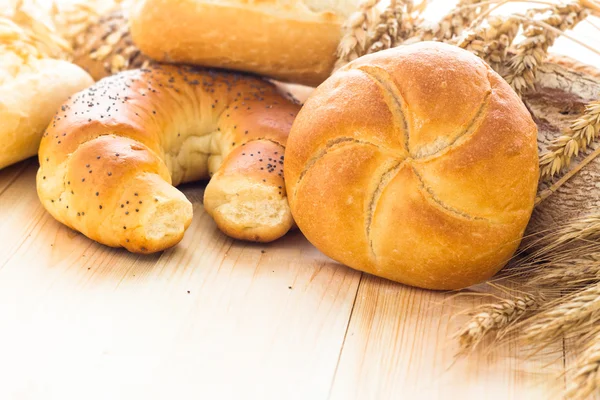 Various bakery products wooden background — Stock Photo, Image