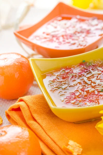 Tasty fruit jelly topped coconut shreds — Stock Photo, Image