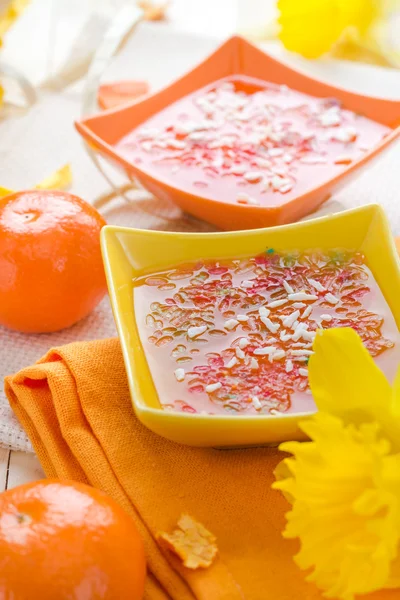 Tasty fruit jelly topped coconut shreds — Stock Photo, Image