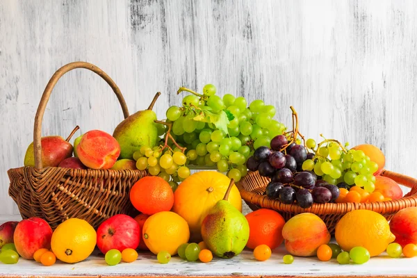 Wooden table full fresh fruit baskets â Stock Photo