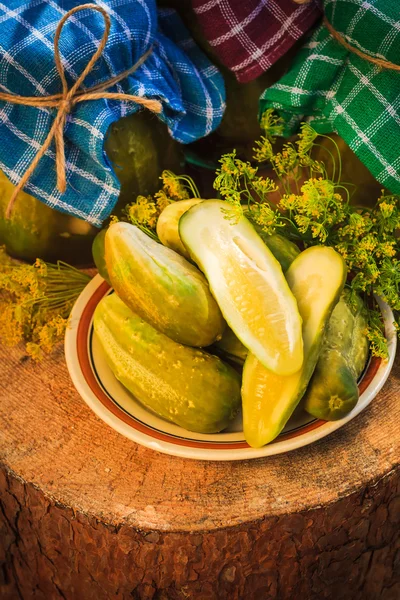 Pickled cucumbers plate jars pickles — Stock Photo, Image