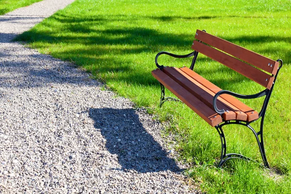 Banco no parque em um fundo de grama — Fotografia de Stock