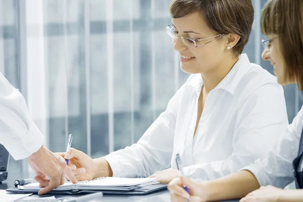 Portrait of young business getting busy in office environment — Stock Photo, Image