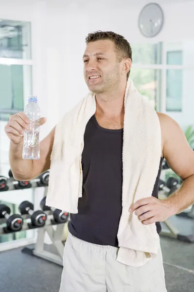 Portrait of young man getting busy in gym Royalty Free Stock Images