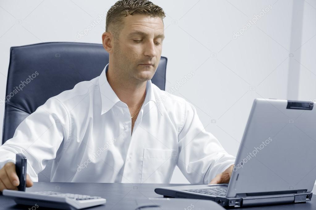 Portrait of young attractive businessman in office environment