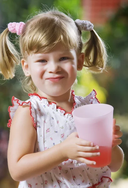 Portrait of little girl having drink in summer environment — Stock Photo, Image