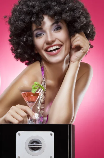 Close up portrait of young woman in afro wig on color back — Stock Photo, Image