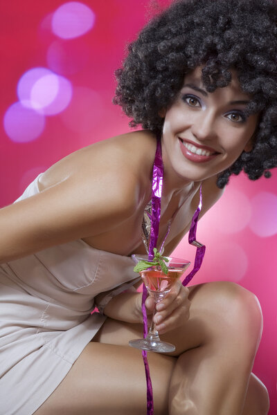 Close up portrait of young woman in afro wig on color back