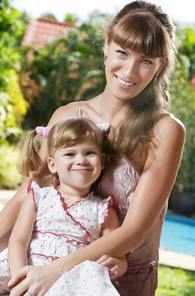 Portrait of happy mother with daughter having good time in summer environment — Stock Photo, Image