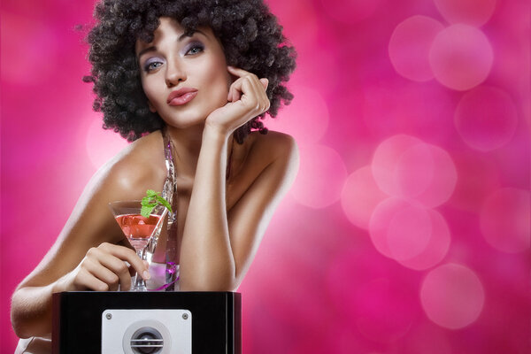 Close up portrait of young woman in afro wig on color back