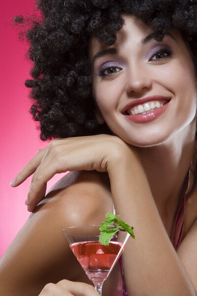 Close up portrait of young woman in afro wig on color back