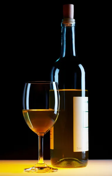 View of bottle of white wine and wineglass beside — Stock Photo, Image