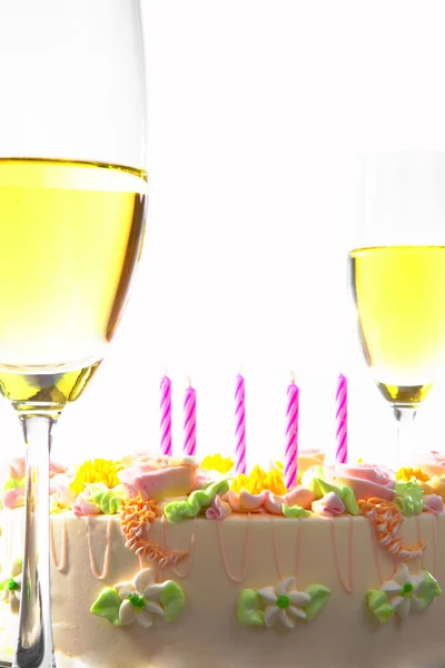 View of nice big delicious cake with candles and champagne — Stock Photo, Image