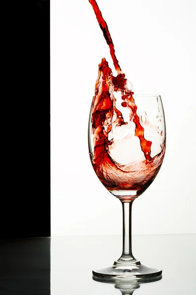 Close up view of wineglass getting filled with red wine — Stock Photo, Image