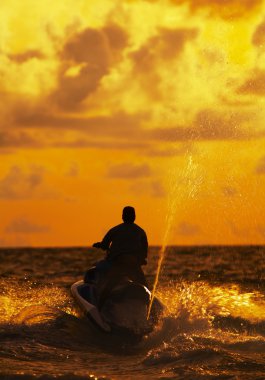 View of jetski rider fiercely struggling with ocean wave clipart