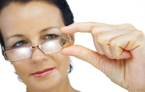 Portrait of woman holding sparkling coin on white back — Stock Photo, Image