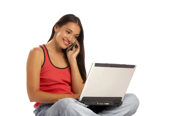 View of young cute emotional brunette sitting behind her laptop — Stock Photo, Image