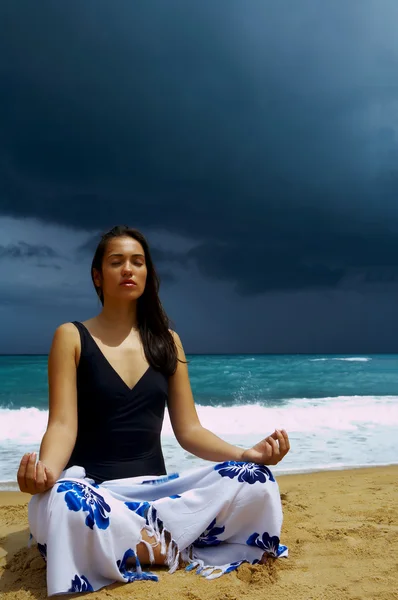 Vista de una joven agradable practicando yoga en la playa tormentosa — Foto de Stock