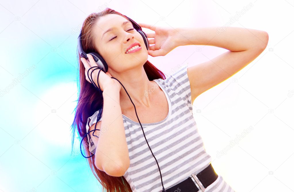 View of young female listening music via earphones. Image may contain slight multicolor aberration as a part of design.