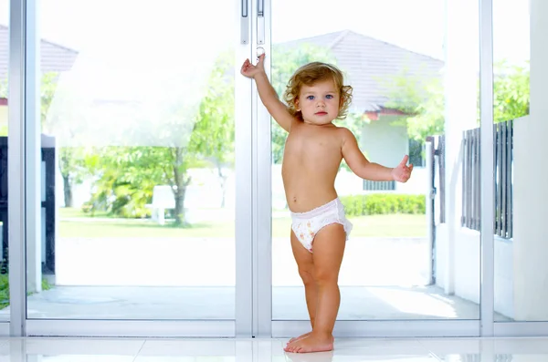 High key portrait of baby trying to get out of house — Stock Photo, Image