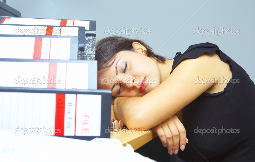 Portrait of a woman dozing on her working place