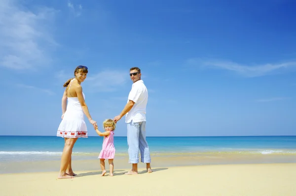 View of young family spending time on the beach — Stok fotoğraf