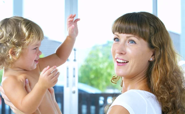 High key portrait of happy mother with baby — Stock Photo, Image