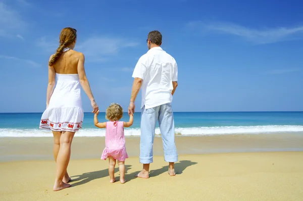 View of young family spending time on the beach — Stok fotoğraf