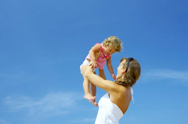 Portrait of young happy mother holding her baby — Stock Photo, Image