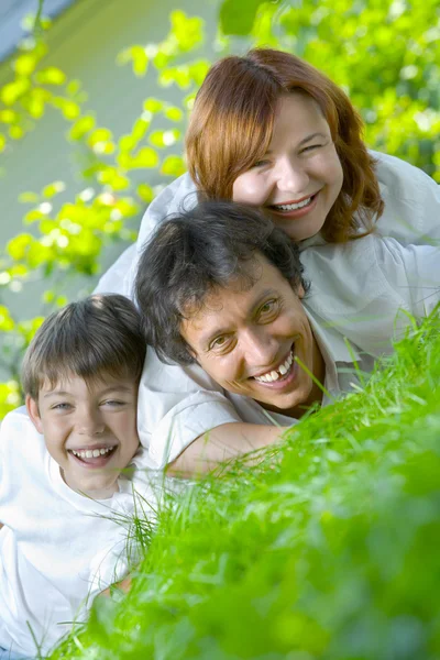 Portrait of young happy family in summer environment — Stock Photo, Image