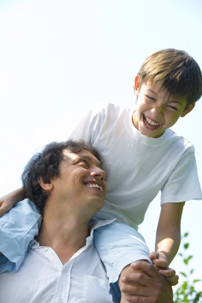 Portrait of young happy father getting busy with his son — Stock Photo, Image