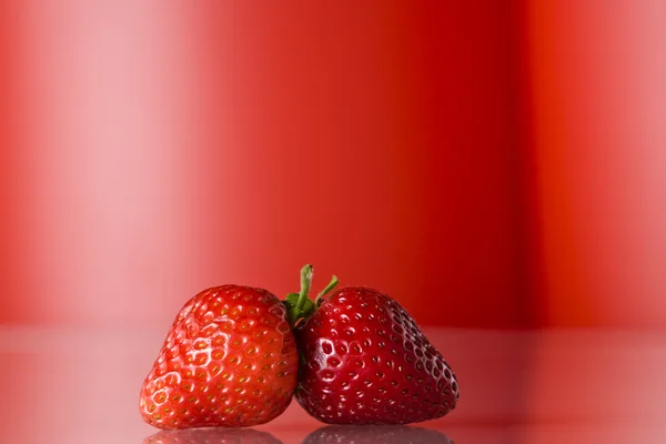 Close up view of nice fresh red berry on red back — Stock Photo, Image