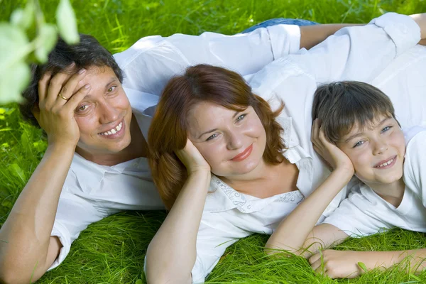 Portrait of young happy family in summer environment — Stock Photo, Image