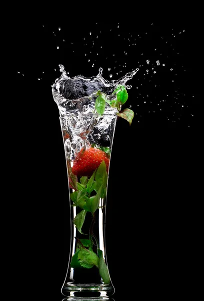 View of soft drink splashing out of glass on black back — Stock Photo, Image