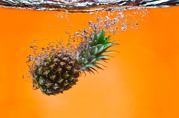 View of nice big pineapple getting through the water — Stock Photo, Image