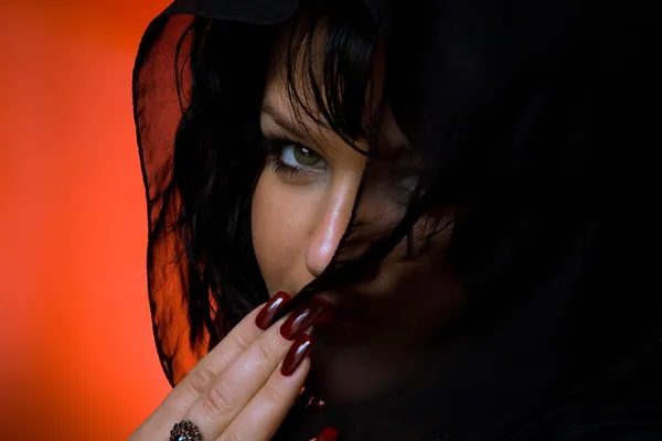 Portrait of young nice woman in black veil on red back — Stock Photo, Image