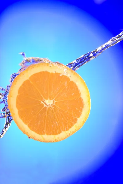 Zblízka pohled plátky oranžové kusu se stříkající vodou — Stock fotografie