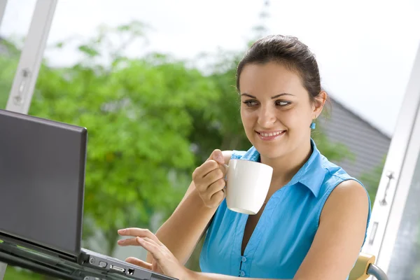 Portrait of young beautiful woman with her laptop Stock Image