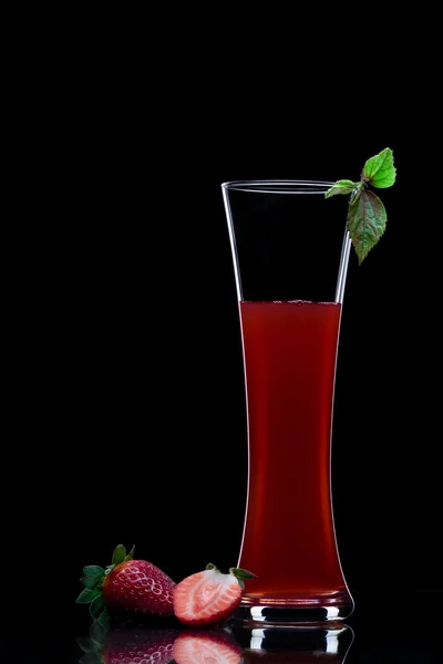 View of strawberry juice splashing out of glass on black back — Stock Photo, Image