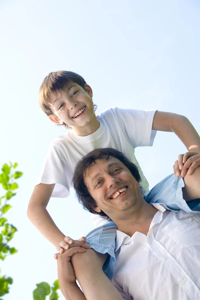 Portrait of young happy father getting busy with his son — Stock Photo, Image